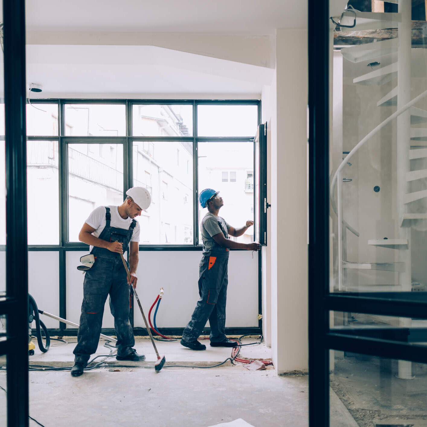 Workers installing wiring in a room