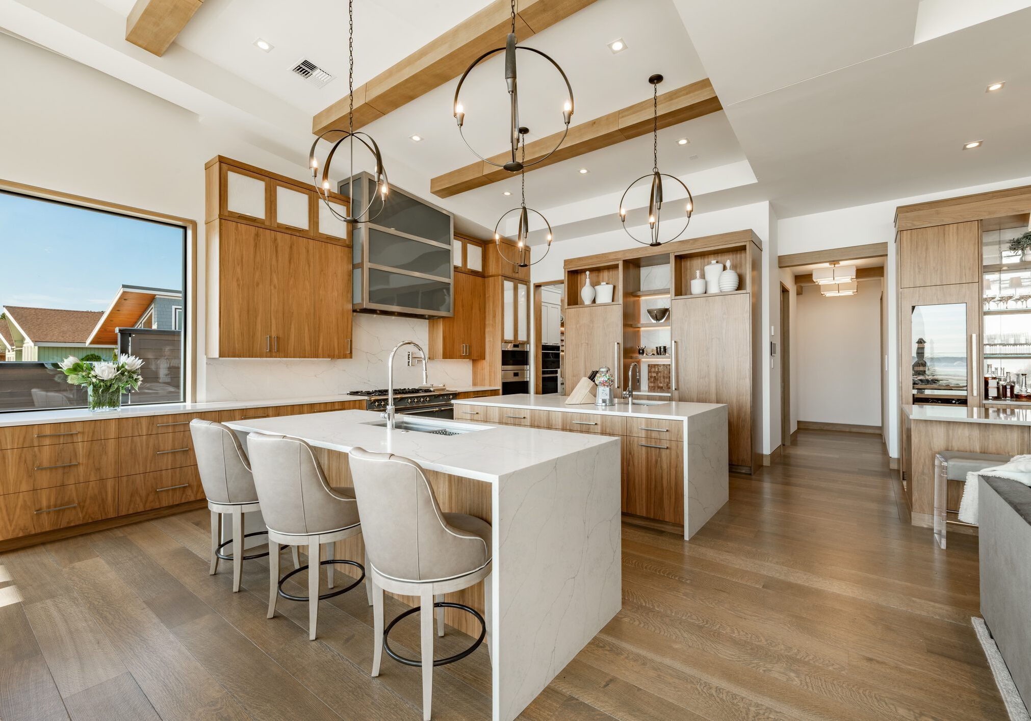 Modern kitchen with white island and wooden cabinetry.